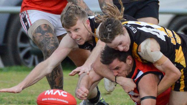 Aldinga's Jake Stangewitz and Tyler Stewart-England tackle Christies Beach’s Jamie Dunn. Picture: AAP/Brenton Edwards