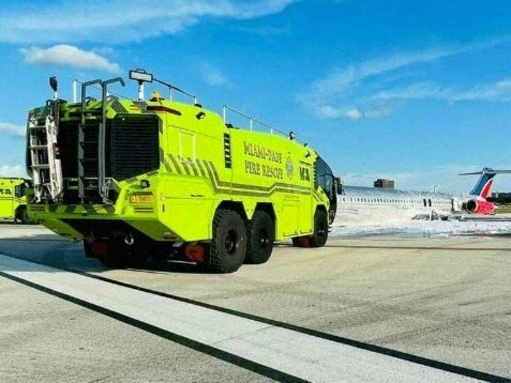 Miami-Dade Fire Rescue extinguish a Red Air jet after it caught fire while landing at Miami International Airport. Picture: Supplied