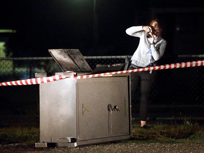 A detective photographs the safe. Photo: Patrick Herve