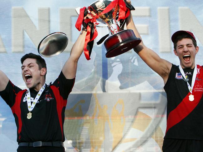 Coach Zane Littlejohn and captain Mitchell Vandenburg lift the cup after North Launceston won the 2014 TSL grand final.