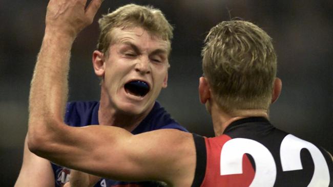 Western Bulldogs ruckman Scott Wynd tussles with Essendon’s John Barnes.