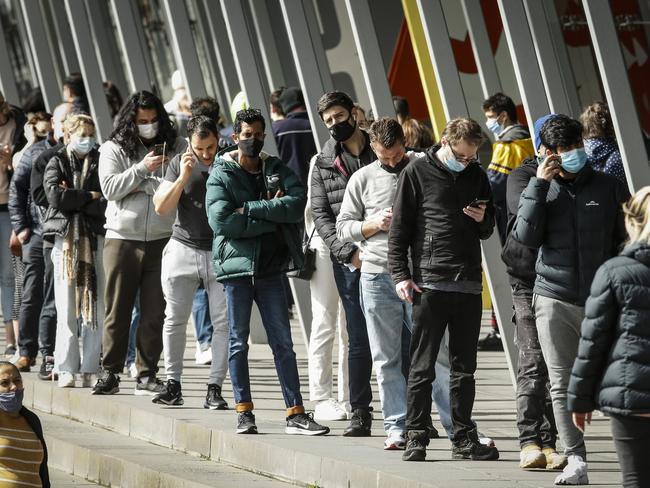 MELBOURNE, AUSTRALIA - AUGUST 25: A large number of people are seen lining up outside the Melbourne Exhibition Centre Vaccine Hub on August 25, 2021 in Melbourne, Australia. Victoria has expanded its COVID-19 vaccination program to allow anyone over the age of 16 access to the coronavirus vaccine from today. The eligibility expansion comes as Victoria aims to reach its goal of administering one million vaccine doses over five weeks. (Photo by Darrian Traynor/Getty Images)