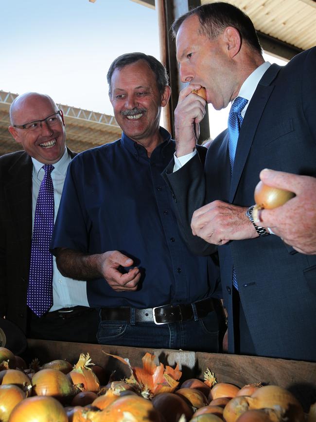 Tony Abbott samples an onion.