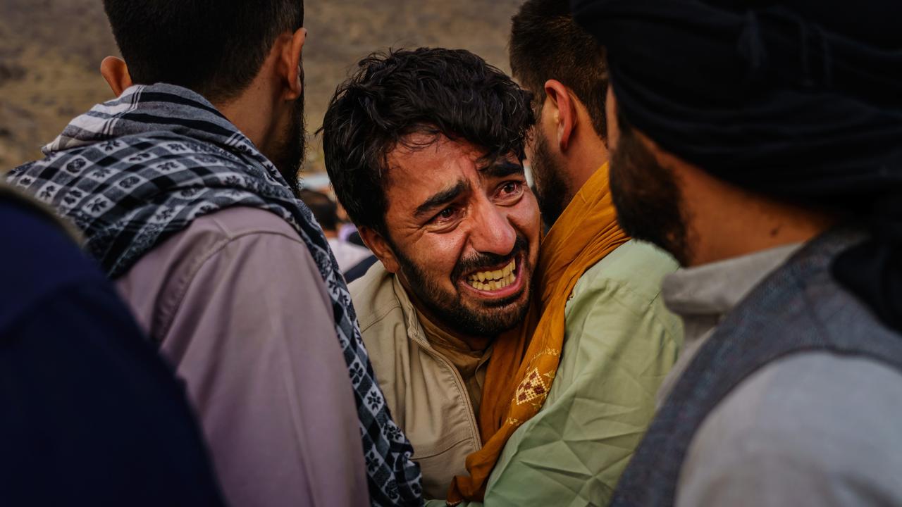 A man grieves during the family’s mass funeral. Picture: Marcus Yam/LA Times