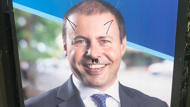 Graffiti on campaign posters for Josh Frydenberg in Melbourne