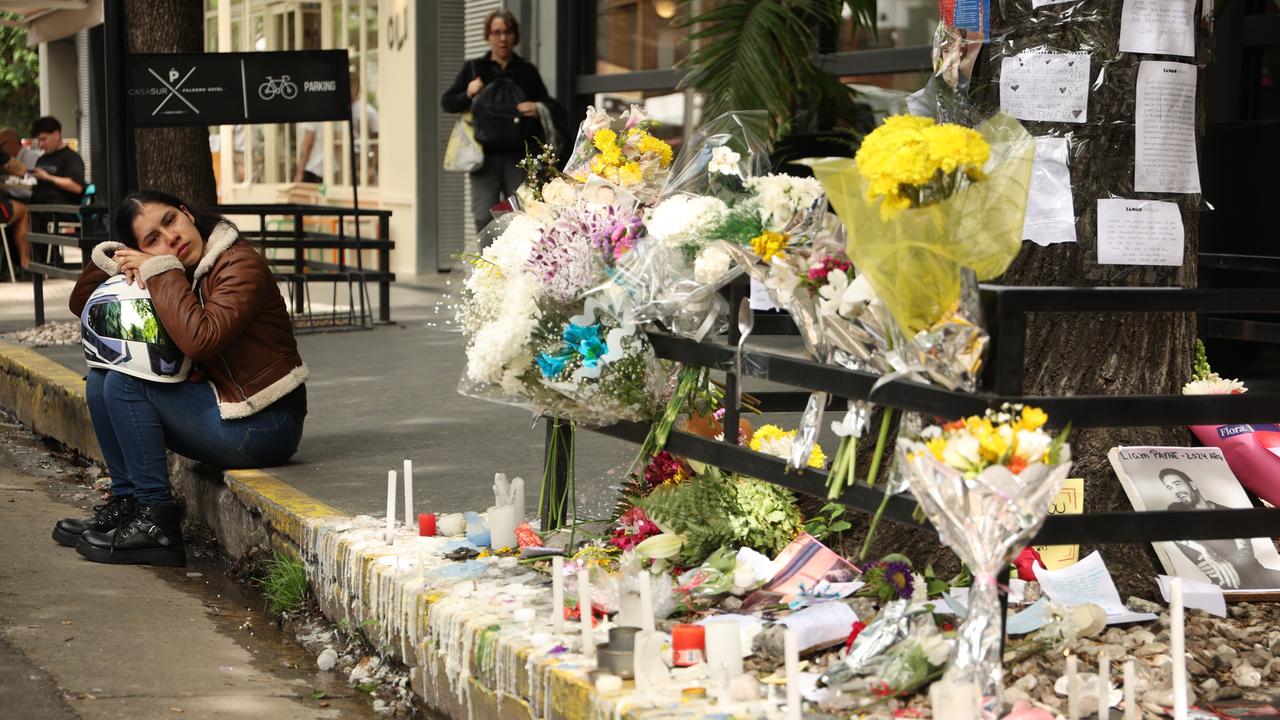 A mourner sits on the street outside the hotel. Picture: Tobias Skarlovnik/Getty Images