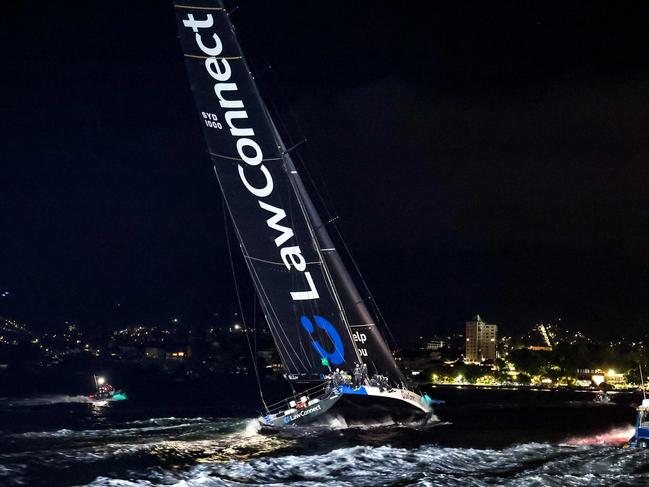 LawConnect raced across the finish line on the Derwent River under the cover of darkness to snare a third line honours win. Picture: AFP