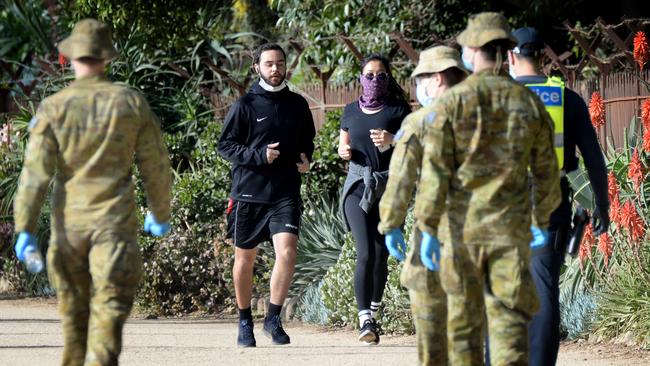 Police and ADF personnel patrol the Tan as Melbourne moves towards stage 4 restrictions. Picture: NCA NewsWire/Andrew Henshaw