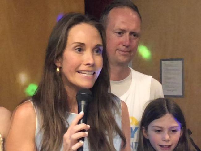 Independent candidate for the Pittwater by-election, Jacqui Scruby, celebrates her likely victory on Saturday night with her husband Michael and their two daughters, and her supporters, at the Avalon Beach Surf Life Saving Club.