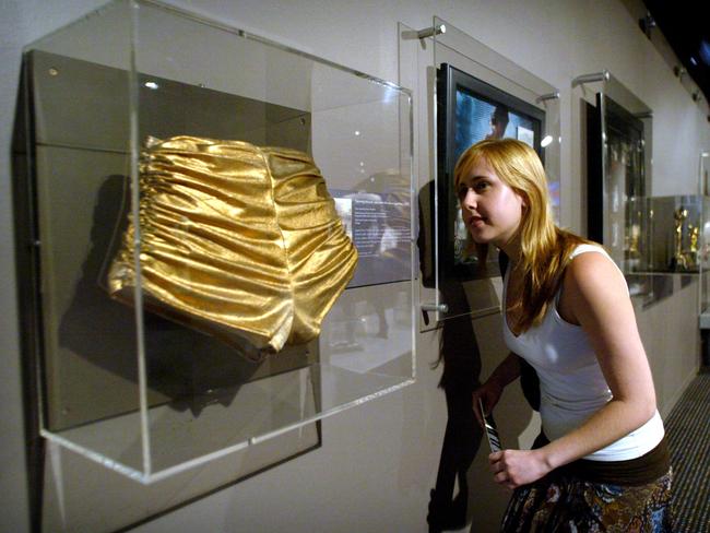 Emma Howarth views Kylie Minogue’s famous gold hot pants during a Sydney exhibition. Picture: Supplied