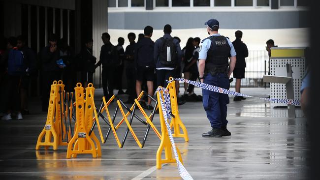 Students and police at the school in Parramatta. Picture: Richard Dobson