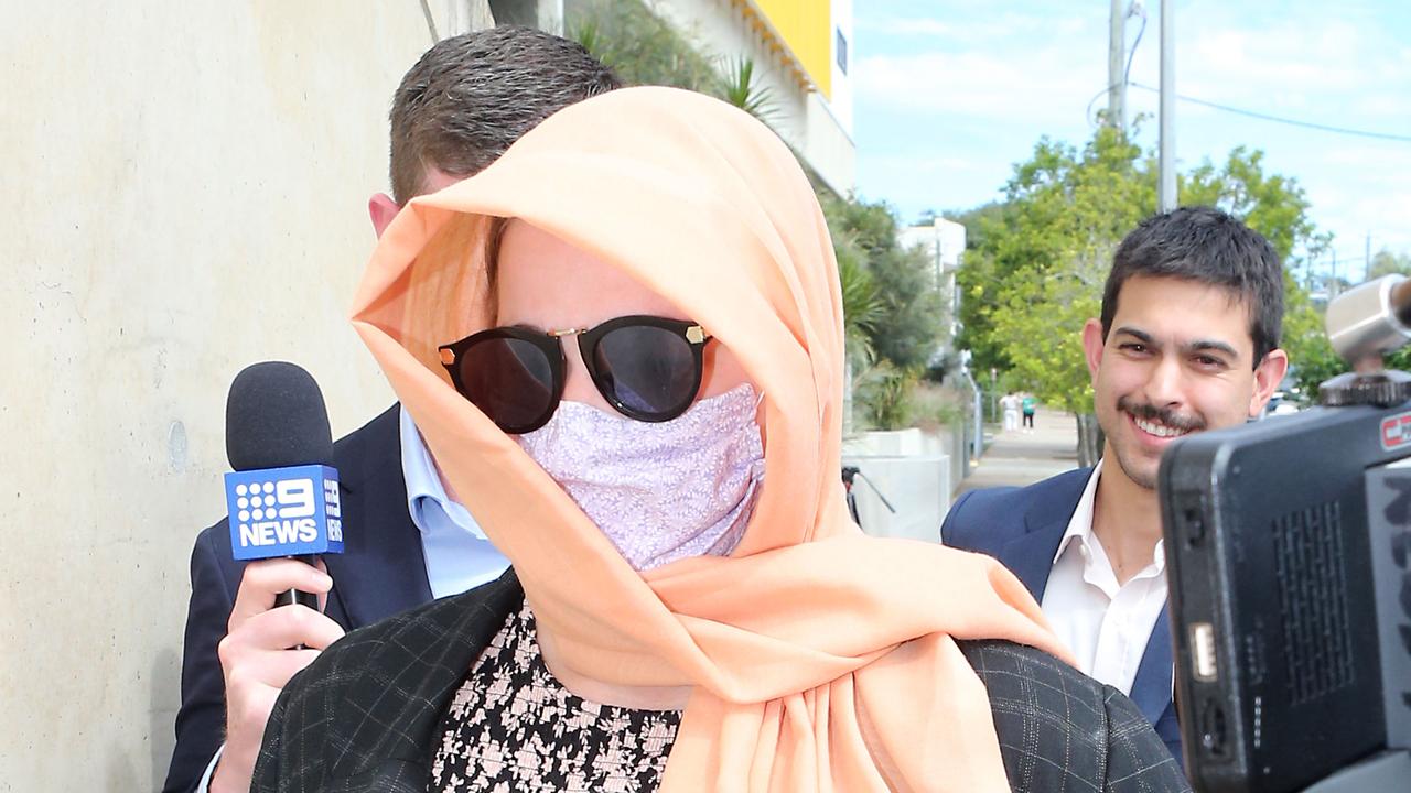 Stephanie Louise Bennett (pictured in a mask and scarf) is charged with two counts of fraud after allegedly nominating dead Sea World pilot Ash Jenkinson on a traffic infringement she received in December. Picture: NCA NewsWire / Richard Gosling