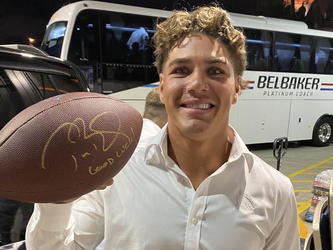 Broncos Reece Walsh with a football signed by Tom Brady.