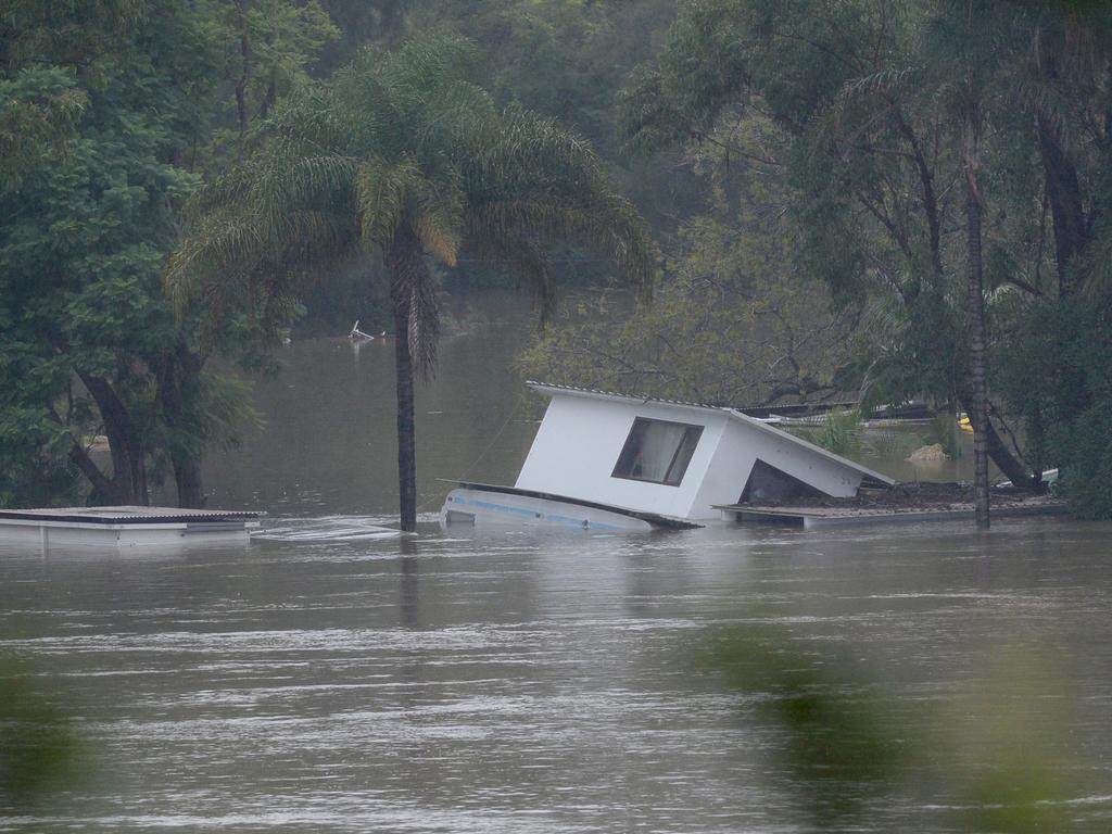 Debris floats in the floodwaters of the Hawkesbury River in Sackville, NSW. Picture: NCA NewsWire / Jeremy Piper