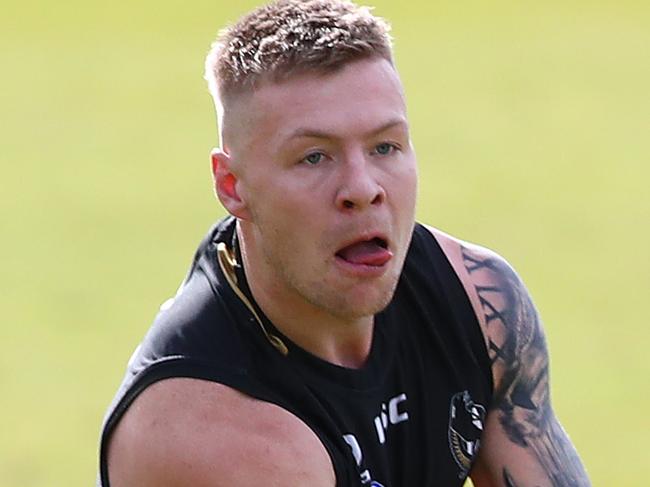 MELBOURNE, AUSTRALIA - AUGUST 21: Jordan De Goey of the Magpies handballs during a Collingwood Magpies AFL training session at The Holden Centre on August 21, 2019 in Melbourne, Australia. (Photo by Kelly Defina/Getty Images)