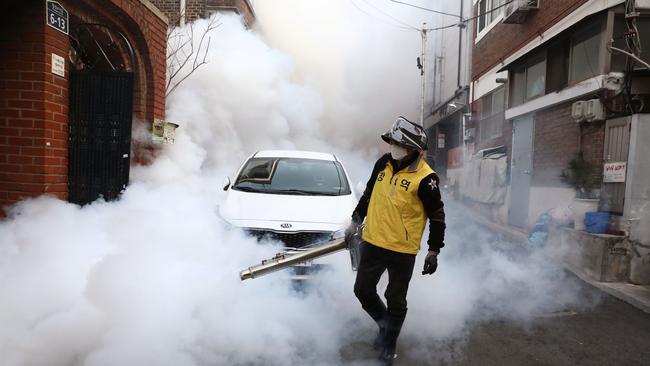 A South Korean man disinfects an alley to prevent the coronavirus spread in Seoul. Picture: Getty Images