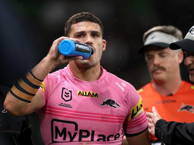 MELBOURNE, AUSTRALIA - MARCH 20: Nathan Cleary of the Panthers is assisted off the field by a trainer for a Head Injury Assessment (HIA) during the round three NRL match between the Melbourne Storm and Penrith Panthers at AAMI Park on March 20, 2025, in Melbourne, Australia. (Photo by Daniel Pockett/Getty Images)