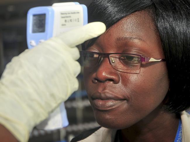 A passenger’s temperature is tested at another airport. (AP Photo/Stephen Wandera)