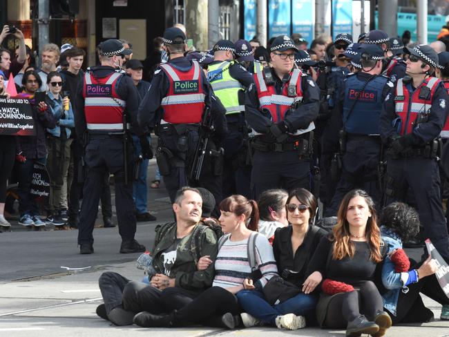 Police begin to remove and arrest vegan protesters who shut down a major Melbourne intersection in April this year. Vegan activists are getting increasingly vocal – and militant. Pictures: Tony Gough