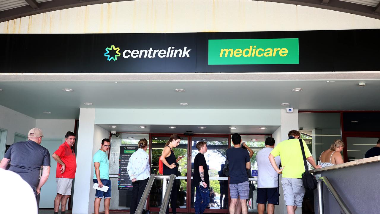 Lines of people wait at Southport Centrelink. Picture: Adam Head.