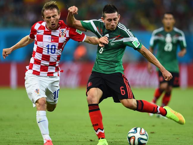 RECIFE, BRAZIL - JUNE 23: Luka Modric of Croatia and Hector Herrera of Mexico compete for the ball during the 2014 FIFA World Cup Brazil Group A match between Croatia and Mexico at Arena Pernambuco on June 23, 2014 in Recife, Brazil. (Photo by Jamie McDonald/Getty Images)