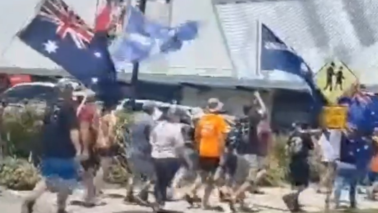 A protest crowd converged on Caneland Central as part of a Mackay freedom rally.