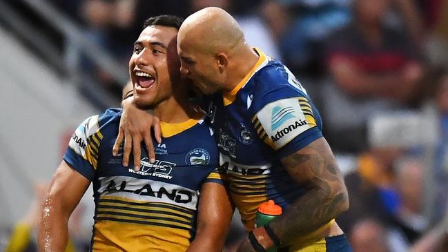 Will Penisini celebrates with Eels teammate Blake Ferguson during the win over Newcastle. Picture: Albert Perez/Getty Images