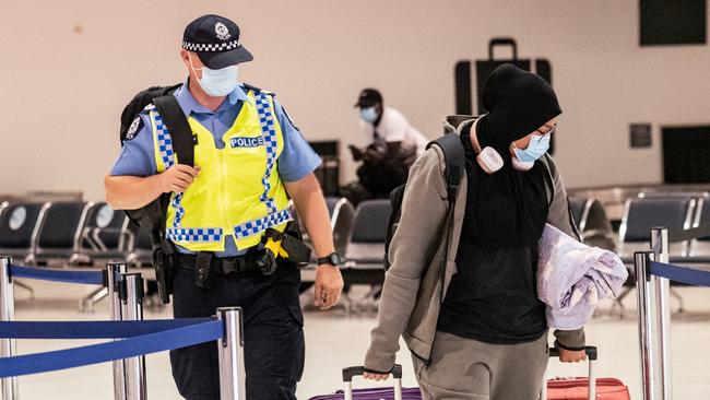 A Passenger is escorted by Western Australia Police at Perth airport. Picture: NCA NewsWire / Tony McDonough