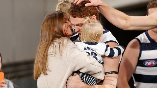 Gary Rohan of the Cats and his partner Madi Bennett embrace as he enters the field for his 150th match with his daughters Bella Ray and Sadie Rose.