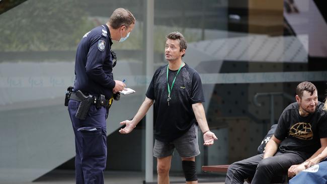 Police questioning people for not wearing masks on the Queen Street Mall. Picture: NCA NewsWire / Josh Woning