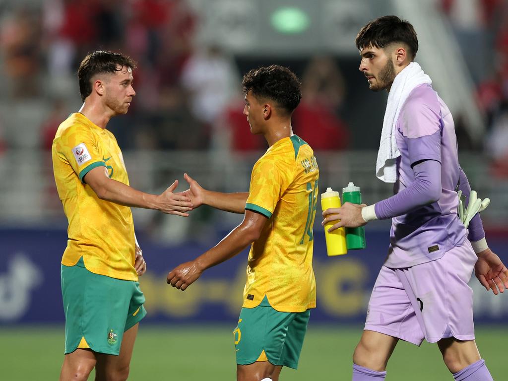 Disappointed Olyroos trio (from left) Lachlan Brook, Jordi Valadon and Patrick Beach reflect on their team’s 1-0 loss to Indonesia. Picture: Mohamed Farag/Getty Images