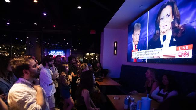 People watch the US presidential debate between Vice-President and Democratic presidential candidate Kamala Harris and former US president and Republican presidential candidate Donald Trump. Picture: AFP