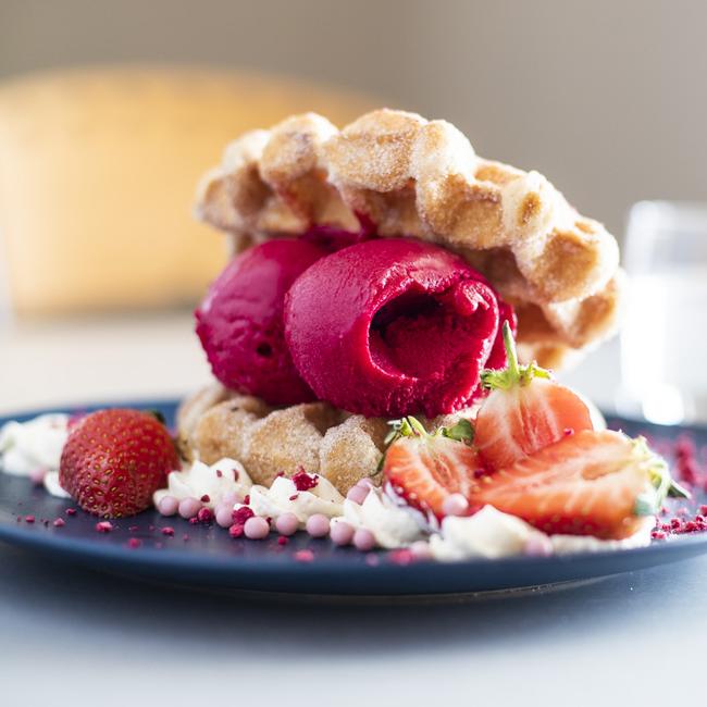 Belgian waffles with raspberry sorbet, fresh berries and whipped cream. Picture: RICHARD JUPE