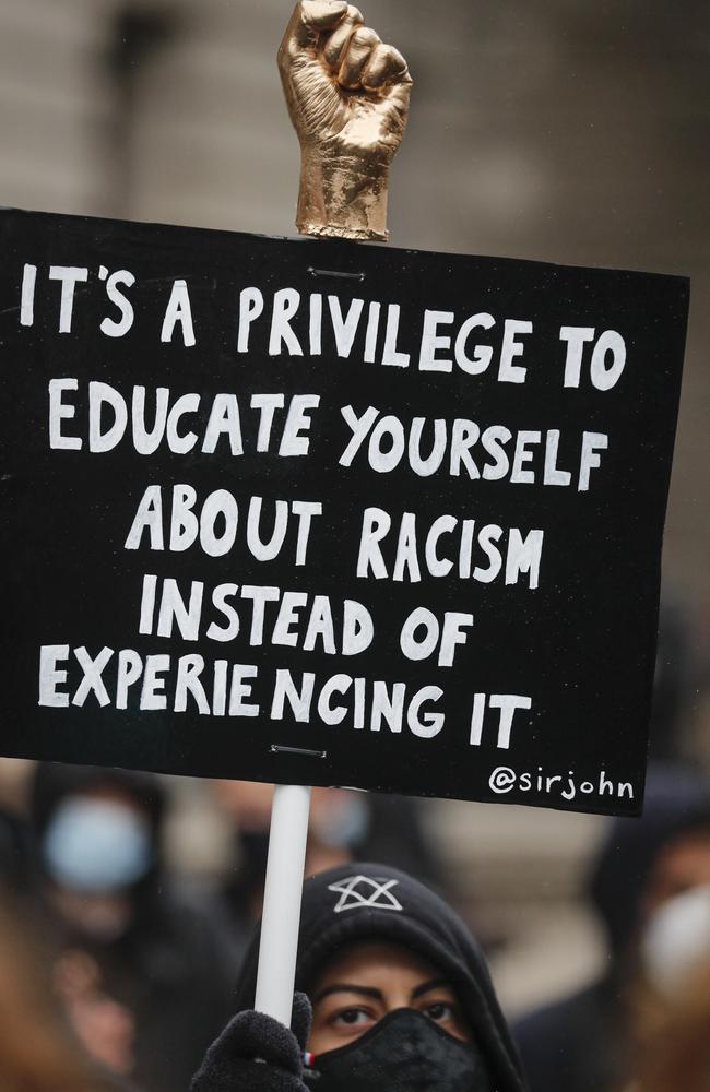 Demonstrators hold placards during a Black Lives Matter rally in Parliament Square in London. Picture: AP