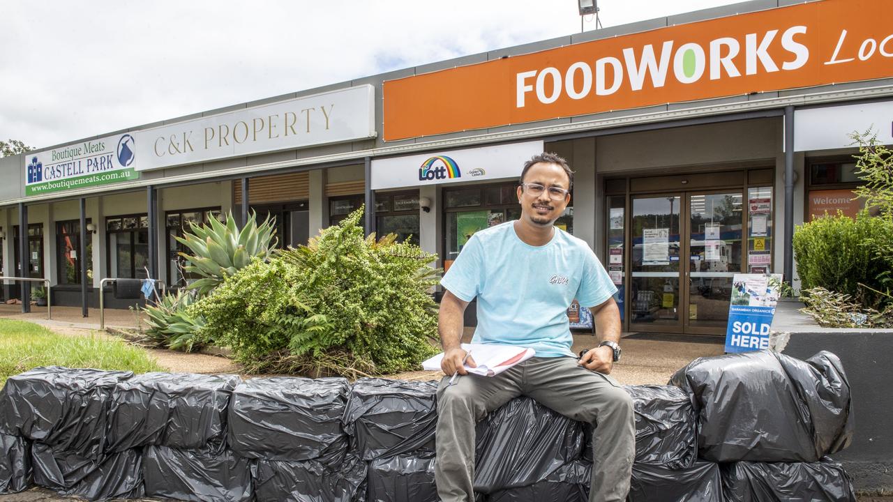 Manager of the Withcott Foodworks Umesh Manandhar made a barrier from bottled water to stop flood water. Monday, February 28, 2022. Picture: Nev Madsen.