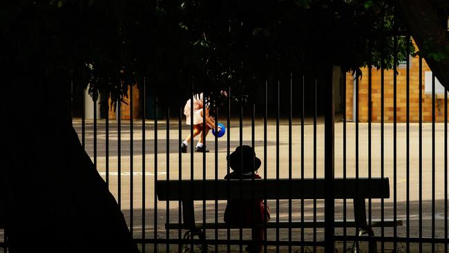 A child is seen in a school yard on Monday. Many students have begun home schooling since. Picture: Jenny Evans/Getty Images)