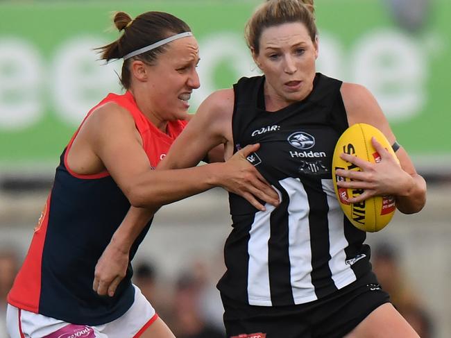 Amelia Barden of Collingwood is tackled by Karen Paxman of Melbourne during their AFLW match at the Ikon Stadium in Melbourne on Saturday, February 11, 2017. (AAP Image/Mal Fairclough) NO ARCHIVING, EDITORIAL USE ONLY