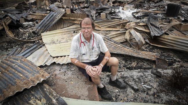 NSW south coast doctor Jeffrey Lee at his burnt-out practice in Cobargo — he is now seeing patients in his caravan. Picture: John Feder