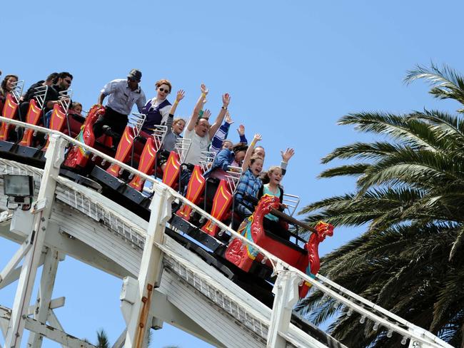 n29ck700 Fun on the rides at Luna Park, St Kilda. Riders on the scenic railway rollercoaster enjoy the downhill ride.