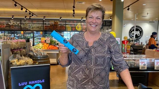 Luv Handle creator Karen Lindsay at the launch of the world-first reusable, dish washable handle fit for any supermarket trolley or basket. Picture: Supplied