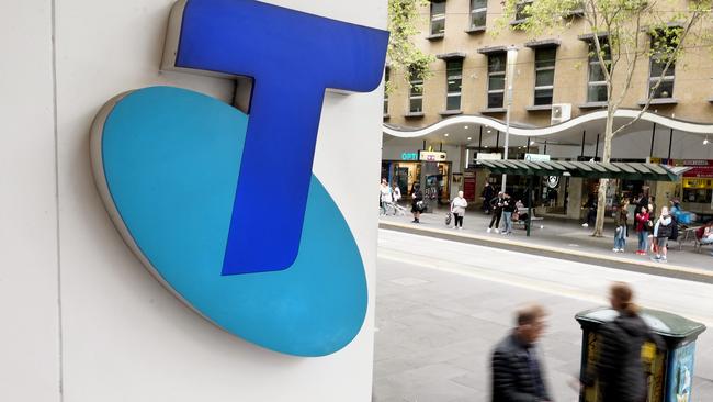 MELBOURNE, AUSTRALIA - NewsWire Photos OCTOBER 4, 2022. Generic photo people walking past the Telstra logo in Melbourne..Picture: NCA NewsWire / Luis Enrique Ascui