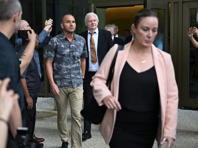 Julian Assange towered over waiting press as he left the US Federal Courthouse in the Commonwealth of the Northern Mariana Islands in Saipan. Picture: AFP