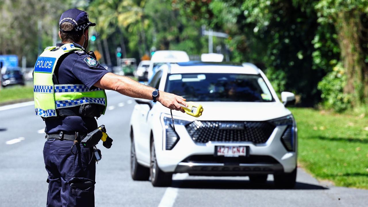 Cairns police have begun National Road Safety Week with a safety blitz. A Queensland Police traffic officer waves drivers to pull over to perform a random breath test on the Captain Cook Highway at Aeroglen. Picture: Brendan Radke