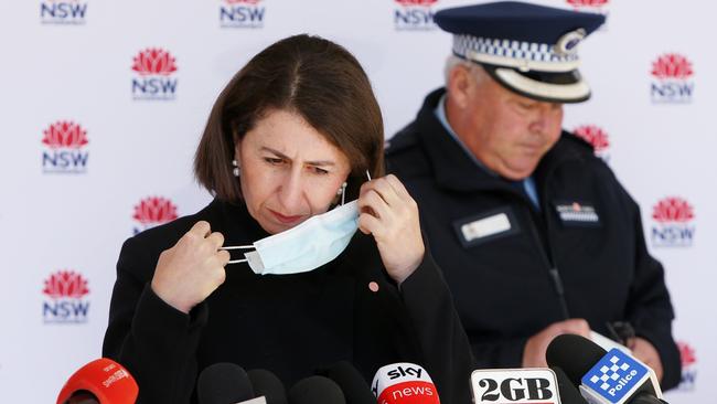 NSW Premier Gladys Berejiklian removes her face mask ahead of confirming lockdown will be extended across Sydney. Picture: Lisa Maree Williams/Getty Images