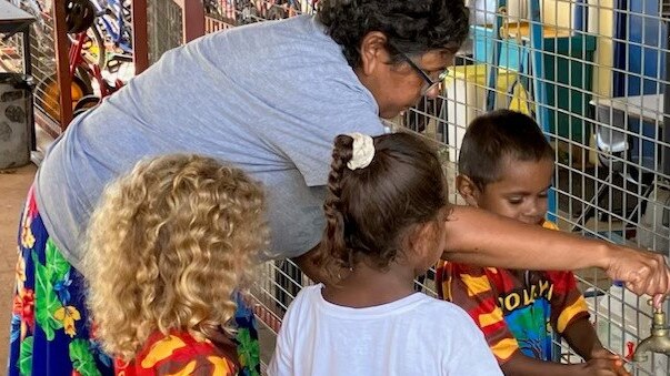 Sharon Daly, a remote educator in Daly River, helping children wash their hands. Picture: Supplied