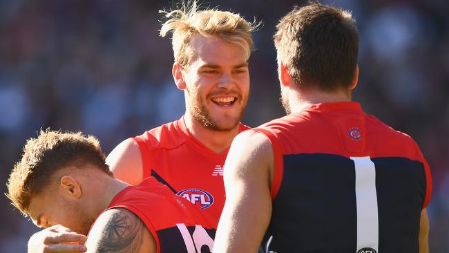 MELBOURNE, AUSTRALIA - APRIL 17: Jack Watts of the Demons is congratulated by Dean Kent and Jesse Hogan of the Demons after kicking a goal during the round four AFL match between the Collingwood Magpies and the Melbourne Demons at Melbourne Cricket Ground on April 17, 2016 in Melbourne, Australia. (Photo by Quinn Rooney/Getty Images)