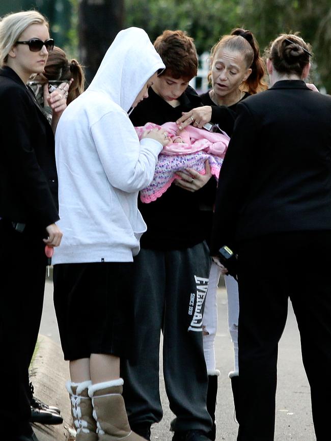 The couple with their newborn after being found by police. Picture: Justin Sanson