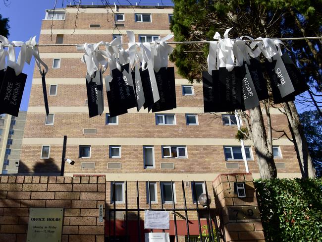 Tags with the names of all 298 passengers who lost their lives onboard MH17 hung between trees out the front of the Russian Consulate in Sydney today. Picture: AAP