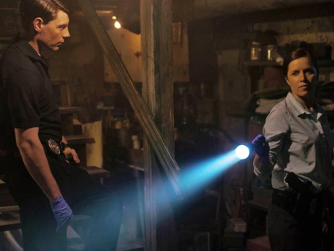 Patrick Fugit, left, and Kim Dickens appear in a scene from Gone Girl.