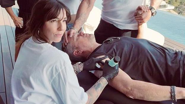 GRAB // Picture: Chris Hemsworth Holds Matt Damon's Hand While He Gets Tattooed whilst their wives, Elsa Pataky and Luciana Damon. They were tattooed by Corina Weikl // https://www.instagram.com/p/C48kbyWrZ1E/?hl=en&img_index=7